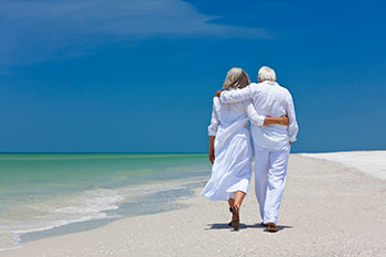 Senior couple walking on beach